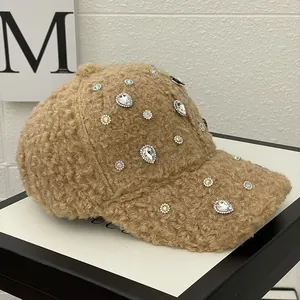 Detail of light brown fleece baseball cap with sparkling rhinestones in a gift box