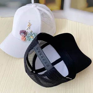 Detail of floral appliques and adjustable mesh back on stylish women baseball caps