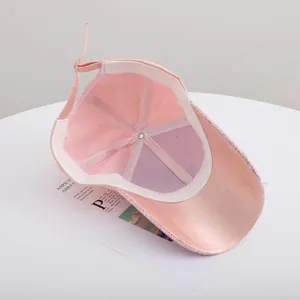 Detail view of pink sequin baseball cap showing interior lining and adjustable strap