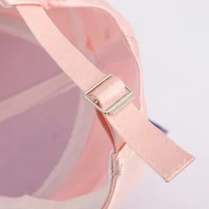 Detail of pink satin baseball cap with adjustable silver metal buckle and silk texture