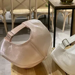 Rear view of satin baseball caps showing metallic adjustable buckle and glossy texture