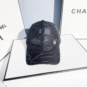 Chic black baseball cap with metallic R logo and silver textured pattern on white box