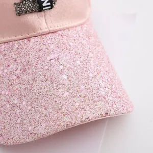 Macro detail of pink sequins and silver rhinestones on a stylish women baseball cap