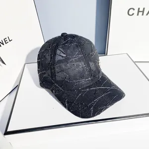Detail of black breathable mesh baseball cap with silver glitter lines and metal R logo