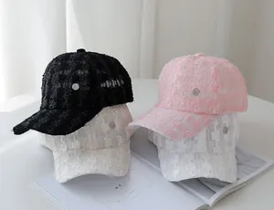 Close-up of tweed baseball caps in black, pink and beige with woven texture and metal logo