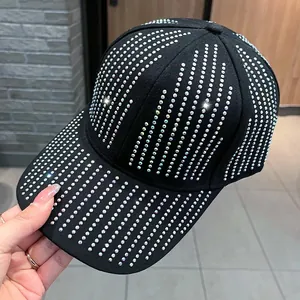 Close-up of sparkling iridescent rhinestones on a stylish black baseball cap detail