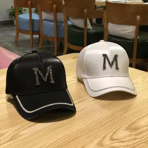 Fashionable satin baseball caps in black and white with rhinestone M letter and trim