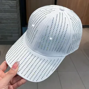 Fashionable white baseball cap with colorful rhinestones for women shown in a hand-held view