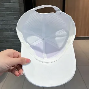 Detail of the white baseball cap interior showing moisture-wicking sweatband and stitching
