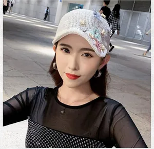 Detailed knit texture of white baseball cap with 3D mesh flowers and pearls