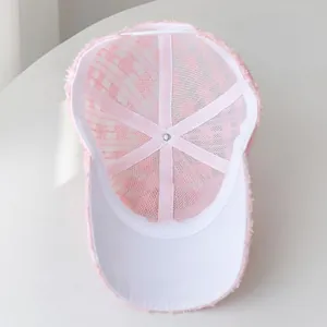 Detail view of pink lace baseball cap showing internal breathable mesh and lining