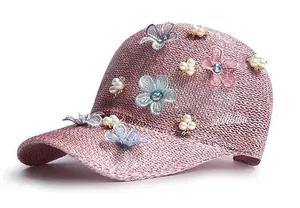 Detail of lavender knitted baseball cap with floral lace, pearls, and butterfly decor