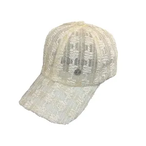 Elegant beige lace baseball cap with floral embroidery and metallic badge detail