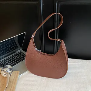 Minimalistische braune Halbmond-Tasche aus Leder mit Litschi-Textur und Trageriemen