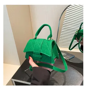 Detailed macro view of the bright green checkered quilted fabric and stitching on handbag