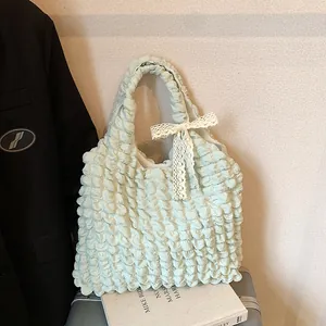 Green popcorn fabric tote bag with white lace bow and chic ruched puff design