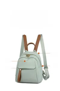 Detail view of the mint green oxford backpack showing four functional storage compartments