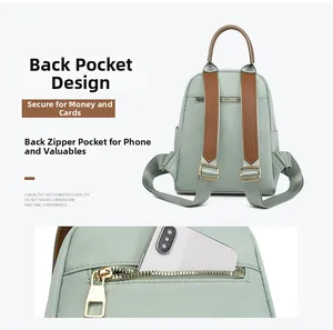 Detail of light green oxford backpack with anti-theft back pocket for phone storage