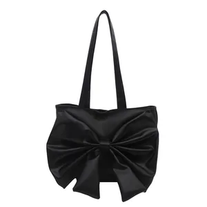 Classic black PU leather tote bag with a stylish large bow design and dual handles