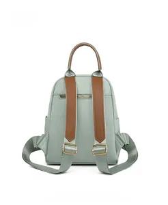 Back view of mint green Oxford fabric backpack showing adjustable straps and hidden pocket