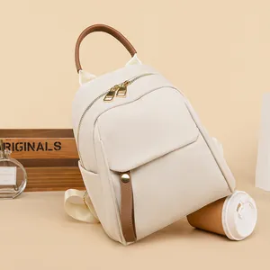 Chic beige oxford mini backpack for women with brown leather accents and top handle