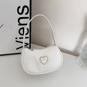 White crescent moon bag with rhinestone heart ornament and golden bow detailing