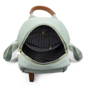 Mint green mini Oxford backpack with brown leather trim and striped lining interior