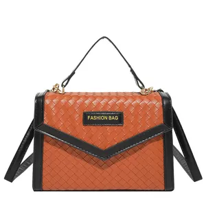Orange woven leather handbag with black trim and detachable shoulder strap for women