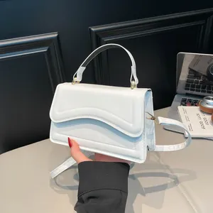 White French-style single shoulder bag with wave pattern quilting and a gold handle