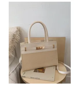 Women's two-tone tote bag in off-white leather and woven straw with gold hardware