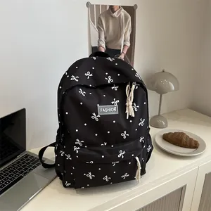 Sac à dos noir à pois blancs avec nœud élégant pour l'école et les voyages loisirs