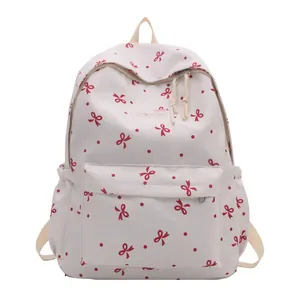 Sac à dos scolaire blanc cassé avec imprimé nœuds rouges et grande capacité