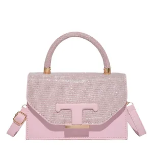 Pink vintage faux leather crossbody bag with sparkling rhinestones and T-shaped buckle