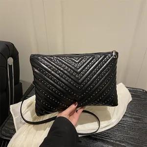 Black V-quilted faux leather shoulder bag with metallic stud details and silver zipper