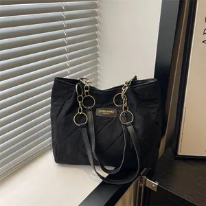 Black quilted tote bag with diamond stitching and gold chain strap for women commute