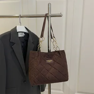 Large dark brown quilted tote bag with diamond stitching and gold chain strap