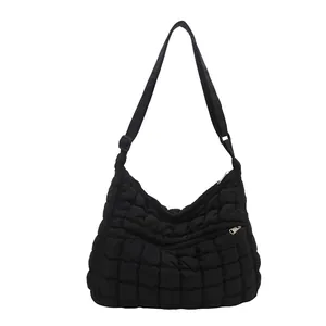 Fashionable black quilted nylon tote bag with front zipper pocket and adjustable strap
