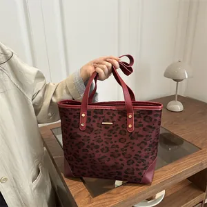 Fashionable dark red leopard print tote bag with leather handles and high texture