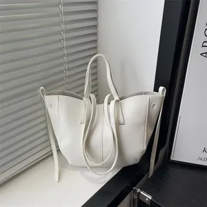 Minimalist white lychee leather tote bag with dual handles and long shoulder strap for women