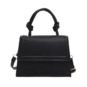 Minimalist black PU leather crossbody square bag with a stylish knotted top handle