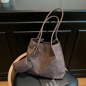 Brown suede tote bag with dual handles and mini coin purse in a vintage style
