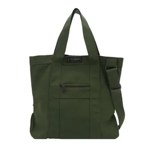 Dark green canvas tote bag with front zipper pocket and adjustable shoulder strap
