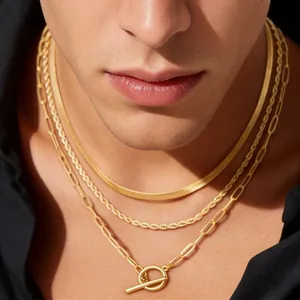Detail of layered gold necklaces with toggle clasp, snake, rope and paperclip chains