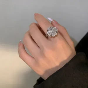 Detailed macro view of a rotating clover ring with zircon stones in silver finish