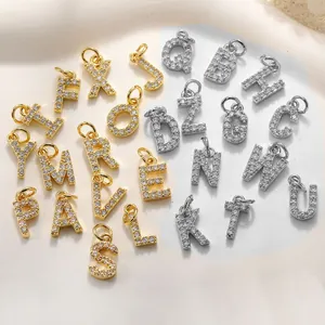 Detailansicht von Gold- und Silber-Buchstaben-Anhängern mit funkelndem Kristall-Besatz