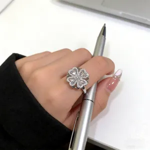 Rotating four-leaf clover ring in silver with micro-set zircon flowers and open band