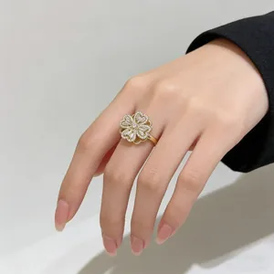 Macro shot of rotating four-leaf clover ring with micro-set zircons on hand