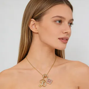 Gold necklace featuring micro-set zircon letter B and pink four-leaf clover heart pendants