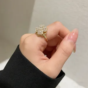 Detail of rotating four-leaf clover ring with micro-set zircons on hand model