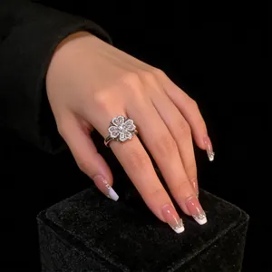 Detailed view of silver clover ring with micro-pave cubic zirconia on black velvet box